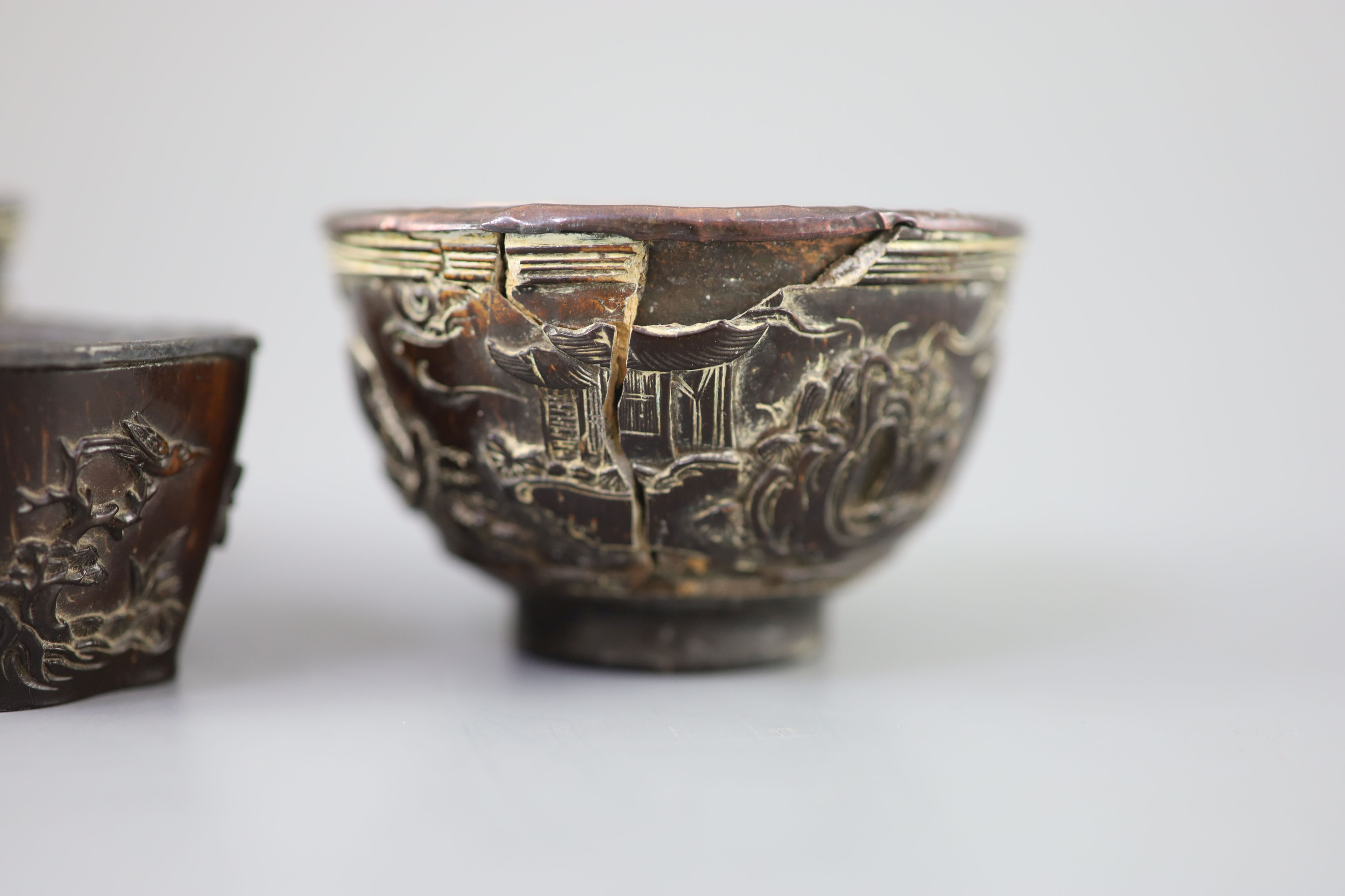 A pair of Chinese coconut landscape cups and a similar peach-shaped cup, 18th/19th century,